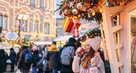 Woman Enjoys a Warm Holiday Drink While Out Shopping