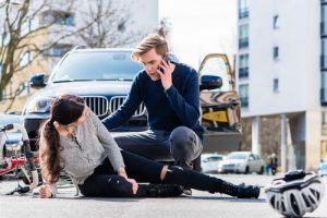 worried young driver calling the ambulance after hitting and injuring accidentally