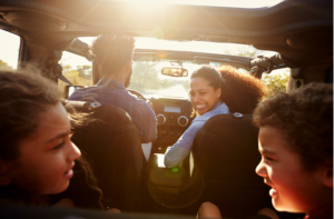 Happy family on a road trip in their car.